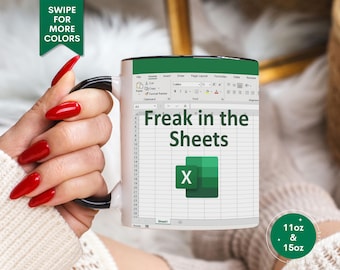 May include: White ceramic mug with a black rim and handle. The mug features a spreadsheet with the text "Freak in the Sheets" and a green "X" in a cell. The mug is available in 11oz and 15oz sizes.