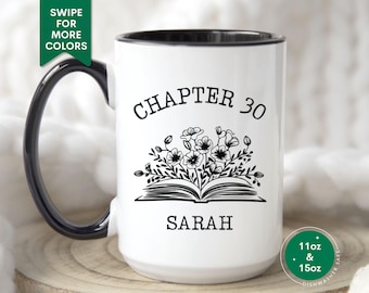May include: White ceramic mug with a black rim and handle. The mug has a black and white design of a book with flowers and the text "Chapter 30 Sarah".