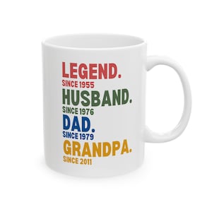 May include: White ceramic coffee mug with the text "LEGEND. SINCE 1955 HUSBAND. SINCE 1976 DAD. SINCE 1979 GRANDPA. SINCE 2011" in colorful text.