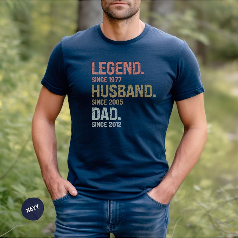 May include: A navy blue t-shirt with a vintage-style graphic that reads "LEGEND. SINCE 1977. HUSBAND. SINCE 2005. DAD. SINCE 2012."