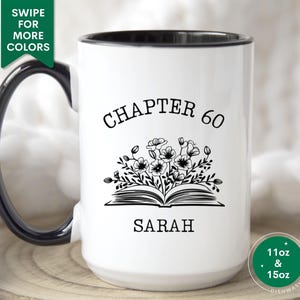 May include: White ceramic mug with a black rim and handle. The mug has a black and white design of an open book with flowers and the text "Chapter 60 Sarah".