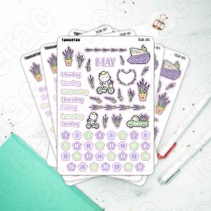 May include: A sheet of stickers featuring a lavender theme with a cat riding a bicycle, a truck full of lavender, and a calendar for the month of May. The stickers are on a white background.