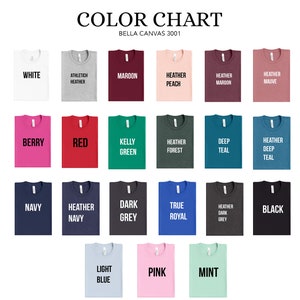 Puede incluir: Carta de colores para camisetas Bella Canvas 3001, mostrando 18 colores diferentes, incluyendo blanco, rojo, azul marino, negro, rosa y verde.