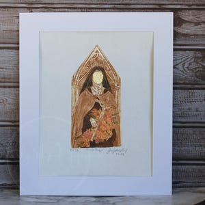 May include: A framed watercolor painting of a figure in a brown cloak holding flowers. The figure's face is covered with gold leaf. The artwork is set against a light background and framed in white.