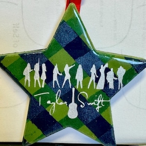 Swiftie star shaped ornament with TS poses and guitar, plaid background