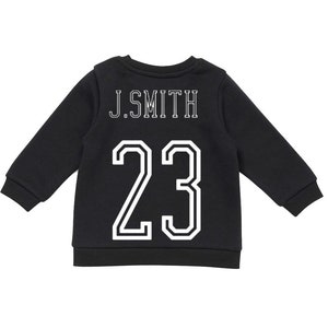 May include: A black long-sleeve sweatshirt featuring the text J.SMITH in white block lettering above the large white number 23. The garment has a ribbed crew neckline, ribbed cuffs, and a ribbed hem, presenting a classic athletic-inspired design.