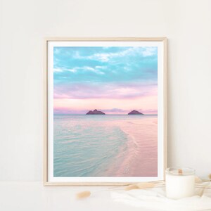Pink and teal pastel beach prints capturing calm ocean horizons, tranquil wall art designed for above-bed styling or cozy coastal interiors.