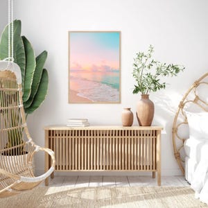 Tranquil coastal print set featuring soft pastel sunset hues over the ocean, elegant pink and teal wall art for modern beach house decor.