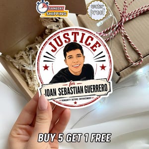 May include: A circular sticker featuring a cartoon illustration of a young person in a black shirt. The text reads JUSTICE for JOAN SEBASTIAN GUERRERO and HUMANITY BEFORE ENFORCEMENT. The design includes red circular borders and two red stars.