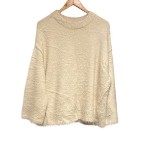 May include: A soft, fluffy, cream-colored sweater with a round neckline and long sleeves.