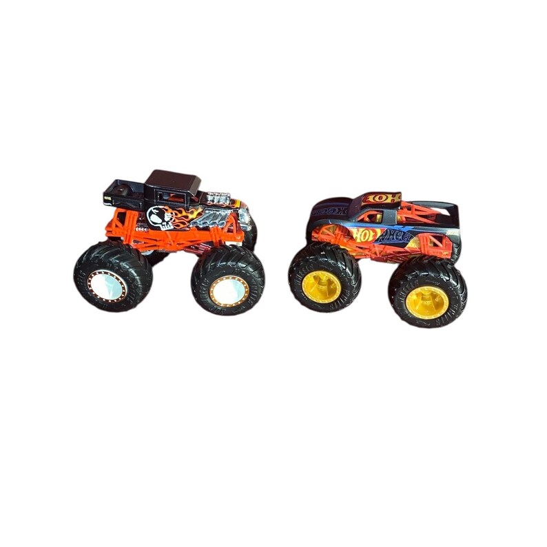 May include: Two toy monster trucks. One is black and orange with a skull graphic, the other is black and blue with orange flames. Both have large black tires and are designed for play.