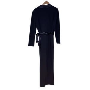 May include: A black long-sleeved jumpsuit with a satin sash tie at the waist.