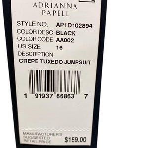 May include: A white tag with black text, a barcode, and a price tag. The tag is for a black crepe tuxedo jumpsuit by Adrianna Papell. The style number is AP1D102894, the color code is AA002, and the size is 16. The manufacturer's suggested retail price is $159.00.