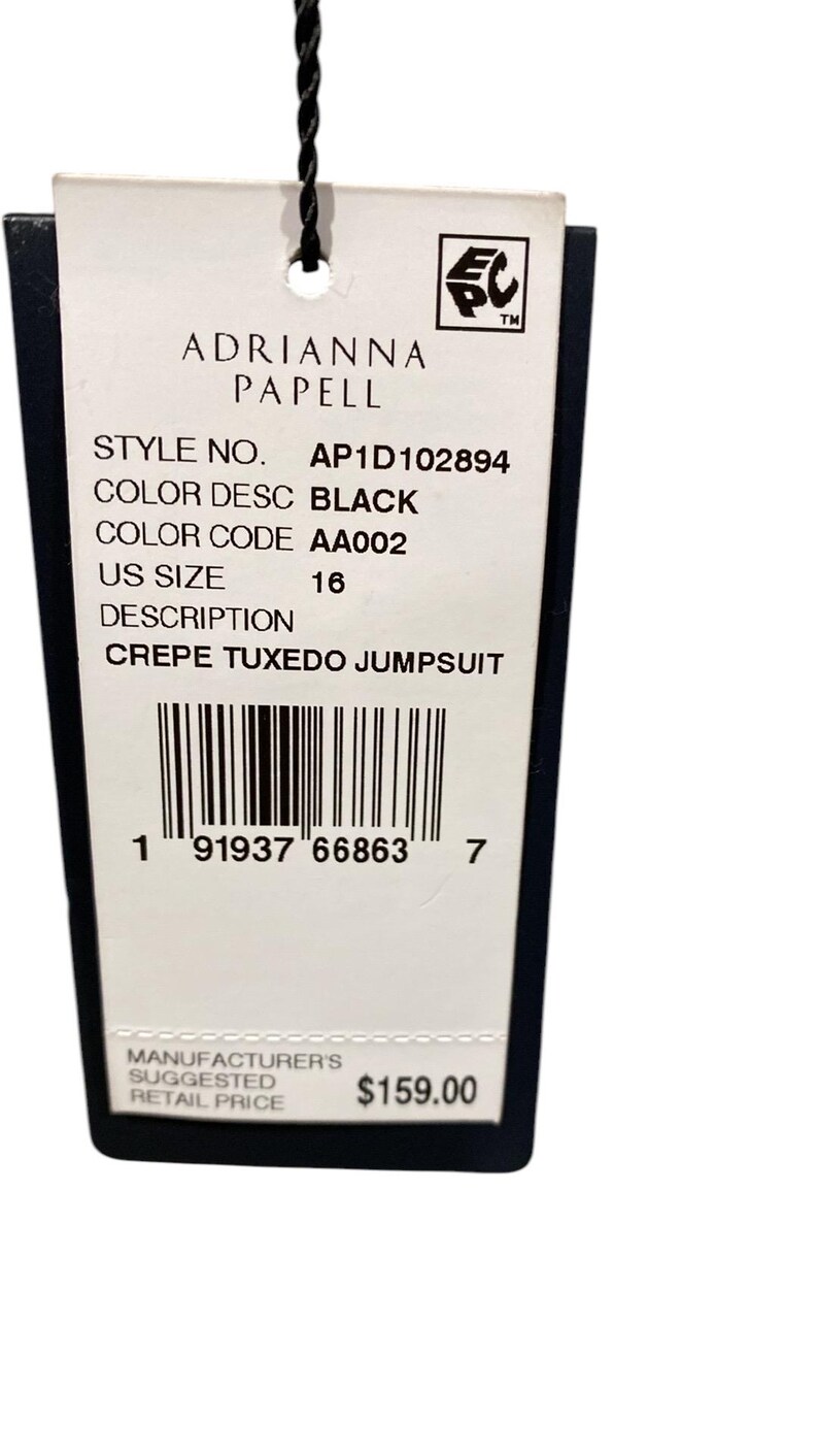 May include: A white tag with black text, a barcode, and a price tag. The tag is for a black crepe tuxedo jumpsuit by Adrianna Papell. The style number is AP1D102894, the color code is AA002, and the size is 16. The manufacturer's suggested retail price is $159.00.