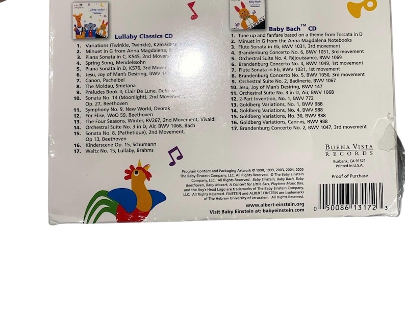 May include: Two CDs, "Lullaby Classics" and "Baby Bach," featuring classical music for children. The packaging includes track listings and a colorful rooster illustration. Buena Vista Records.