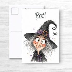 May include: A rectangular greeting card featuring a watercolor illustration of a witch with messy gray hair, a large nose, and a single tooth. She wears a black pointed hat with a purple band and buckle. A small spider hangs from the hat. The text Boo! is printed above.