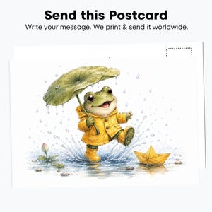 May include: A postcard featuring a watercolor illustration of a green frog wearing a yellow raincoat and boots, holding a large green leaf as an umbrella while splashing in a puddle next to a yellow paper boat. Text reads: Send this Postcard.