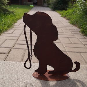 Patina dog sitting with leash on floor plate
