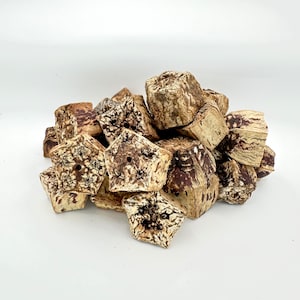 May include: A pile of brown and white star-shaped wooden blocks. The blocks are made of natural wood and have a rustic look.