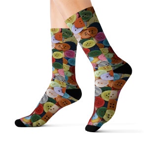 May include: A pair of colourful socks with a button pattern. The socks are made of a soft, comfortable material and are perfect for adding a touch of whimsy to any outfit.