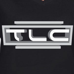 May include: A black V-neck t-shirt featuring a graphic print on the chest. The design consists of the letters TLC in a bold, white, sans-serif font, enclosed within a rectangular grey frame with additional horizontal bars above and below.