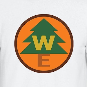 May include: White t-shirt with a brown and orange circle containing a green pine tree with the letters "W" and "E" inside.