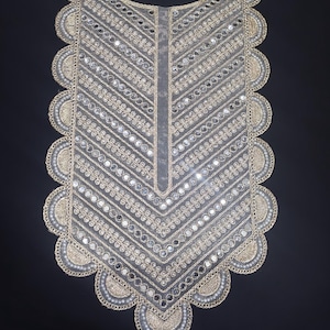 May include: A decorative neckline appliqué featuring a scalloped edge with gold embroidery and small white beads. The centre panel is made of sheer grey fabric adorned with rows of reflective circular mirrors and gold thread stitching in a chevron pattern.