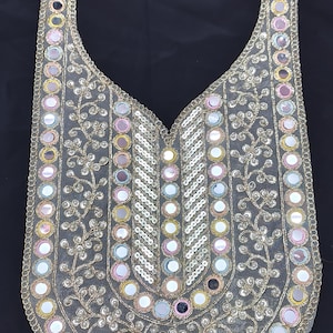 May include: A U-shaped neckline applique featuring intricate gold thread embroidery, floral vine patterns, and numerous circular mirrors with pink, blue, and yellow borders. The design includes vertical and curved rows of reflective mirror accents.