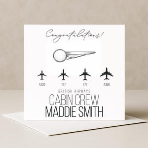 May include: A square greeting card with the text Congratulations! at the top. Below is a silver airplane pin graphic, followed by four black airplane silhouettes labelled A320, 787, 777, and A380. The text British Airways Cabin Crew Maddie Smith is printed below.