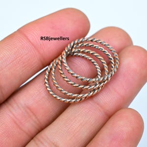 May include: Four silver and rose gold twisted band rings. RSBjewellers.