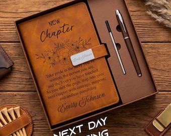 May include: A tan leather-like journal with the text New Chapter and a floral design, featuring a metal nameplate reading Emily Johnson. The journal is inside a brown gift box with a matching pen and a thin metal stylus. A leather pouch and golf tees.
