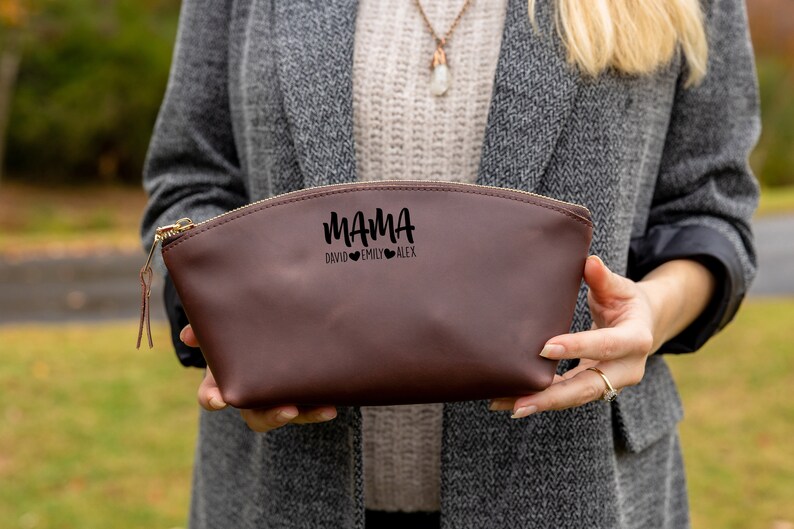 May include: A brown leather zippered pouch with the text "MAMA DAVID EMILY ALEX" and three small hearts.