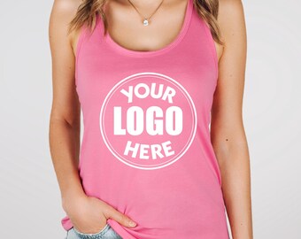 May include: A pink racerback tank top with the text "YOUR LOGO HERE" in a white circular design. The tank top is a solid pink color and is made of a soft material.