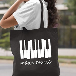 May include: Black tote bag with a white piano keyboard graphic and the text "make music".