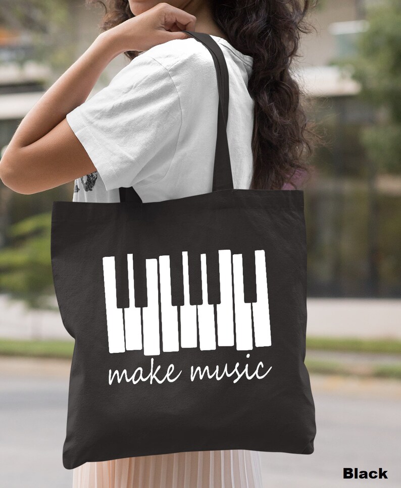 May include: Black tote bag with a white piano keyboard graphic and the text "make music".