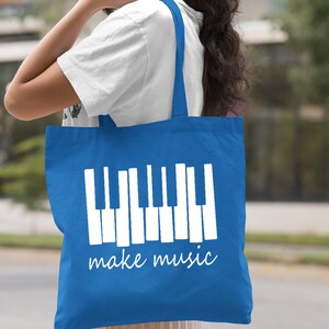 May include: A royal blue tote bag with white handles and a white graphic of a piano keyboard with the text "make music".