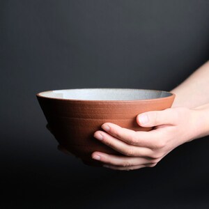 Handmade ramen bowl in red stoneware and white glaze