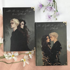 May include: A set of three ceramic vases in varying heights and shapes. The vases are glazed in a matte white finish, offering a minimalist aesthetic. The tallest vase is approximately 10 inches high.