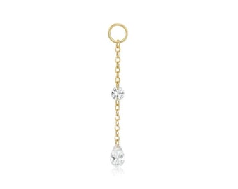 May include: A gold chain with two clear round gemstones and a pear-shaped gemstone dangling from the bottom.