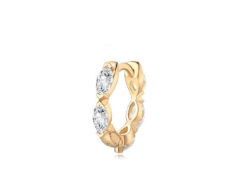 May include: Gold hoop earring with clear cubic zirconia stones set in a pave setting.