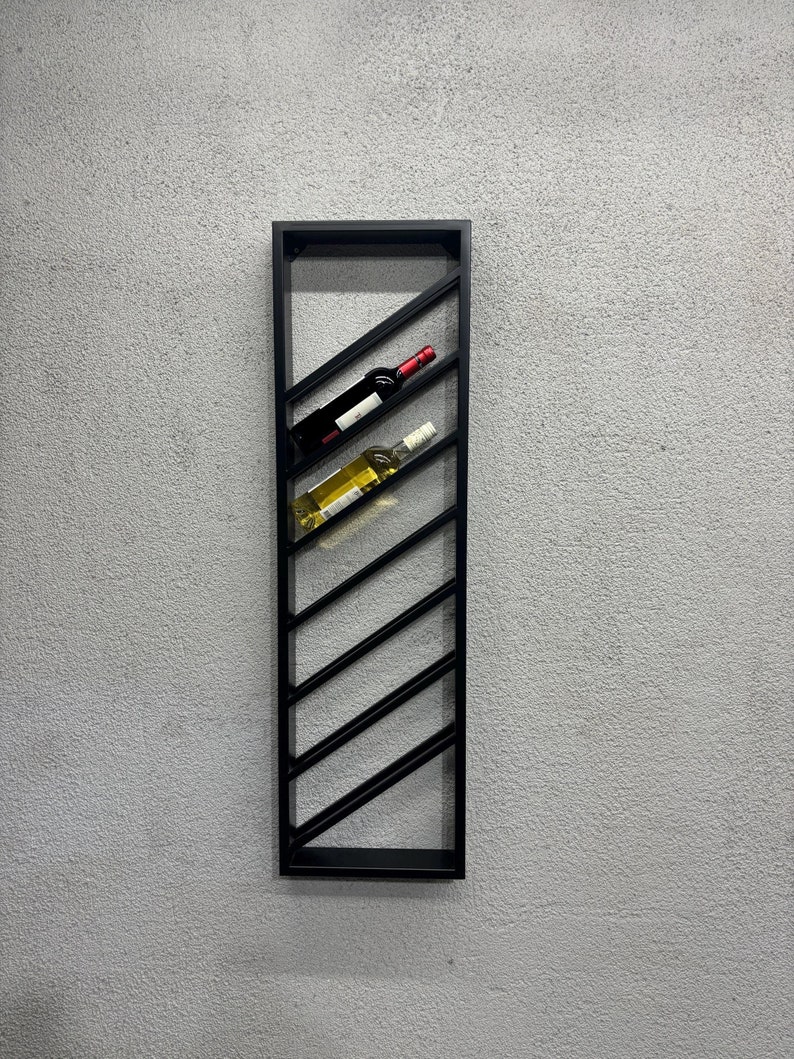 May include: A black metal wine rack with a diagonal design, holding two bottles of wine. One bottle is red wine and the other is white wine.