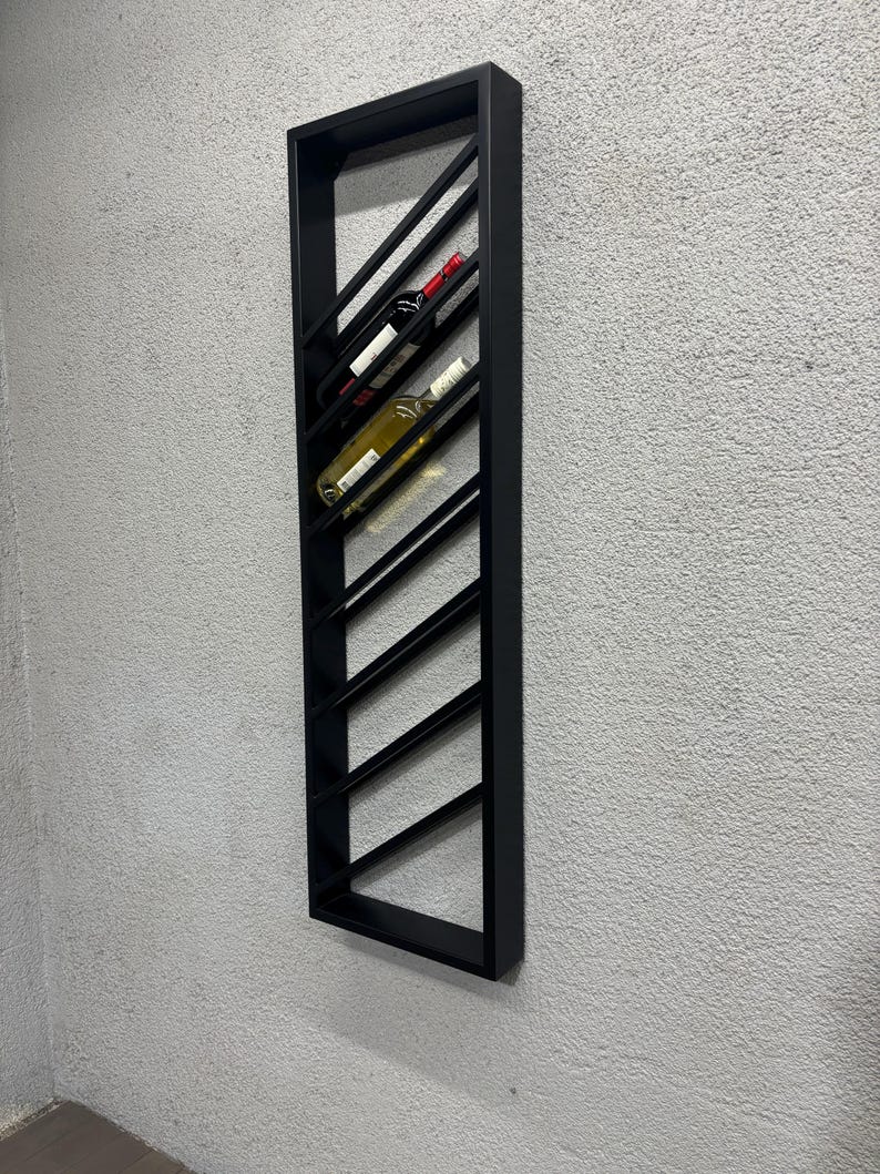 May include: Black metal wall-mounted wine rack with a diagonal design. The rack holds multiple bottles of wine.