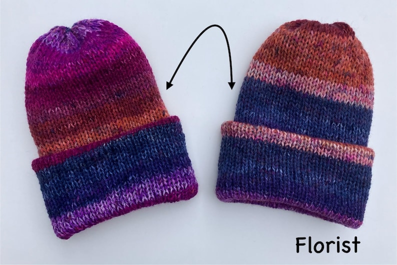 May include: Two hand-knitted beanies with a folded brim. The hats feature a color gradient from dark purple to orange and brown. The word "Florist" is printed in white at the bottom of the image.