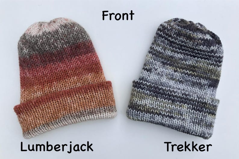 May include: Two knitted beanies. The "Lumberjack" beanie features a gradient of colors from brown to red. The "Trekker" beanie is gray, black, and green. The word "Front" is above the beanies. The word "Lumberjack" is below the first beanie. The word "Trekker" is below the second beanie.