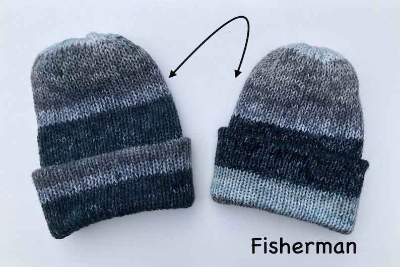 May include: Two knitted beanies in shades of gray, blue, and black, with a folded brim. The word "Fisherman" is written in black text below the beanies. The beanies are made of a soft, textured yarn.
