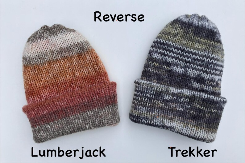 May include: Two knitted beanies, one in Lumberjack colors of brown, orange, and red, and the other in Trekker colors of gray, white, and black. The word "Reverse" is above the beanies. The word "Lumberjack" is below the first beanie, and "Trekker" is below the second.