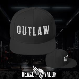 May include: Black baseball cap with a flat brim, featuring the word "OUTLAW" in white embroidered lettering. The cap has a structured design. The logo "REBEL AND VALOR" is at the bottom.