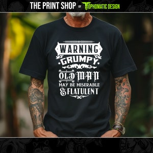 Może przedstawiać: Czarny T-shirt z białym nadrukiem, na którym widnieje napis "Warning Grumpy Old Man May Be Miserable & Flatulent".