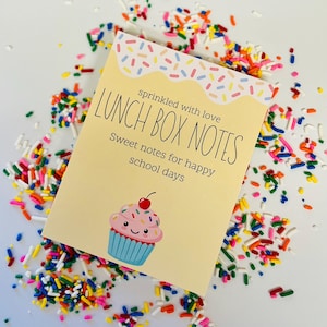 May include: A light yellow Lunch Box Notes card with a cupcake illustration and colorful sprinkles. The card reads "sprinkled with love" and "Sweet notes for happy school days."