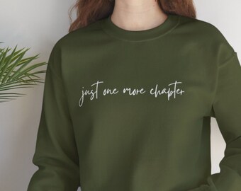May include: A green sweatshirt with the text "just one more chapter" in white lettering.